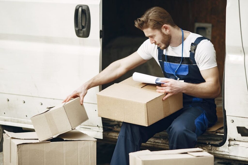  Showcasing a man who works for one of the courier services in London sorting his parcels