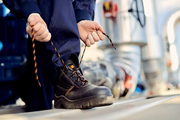 A Plumber Wearing Boots Before Going To Work